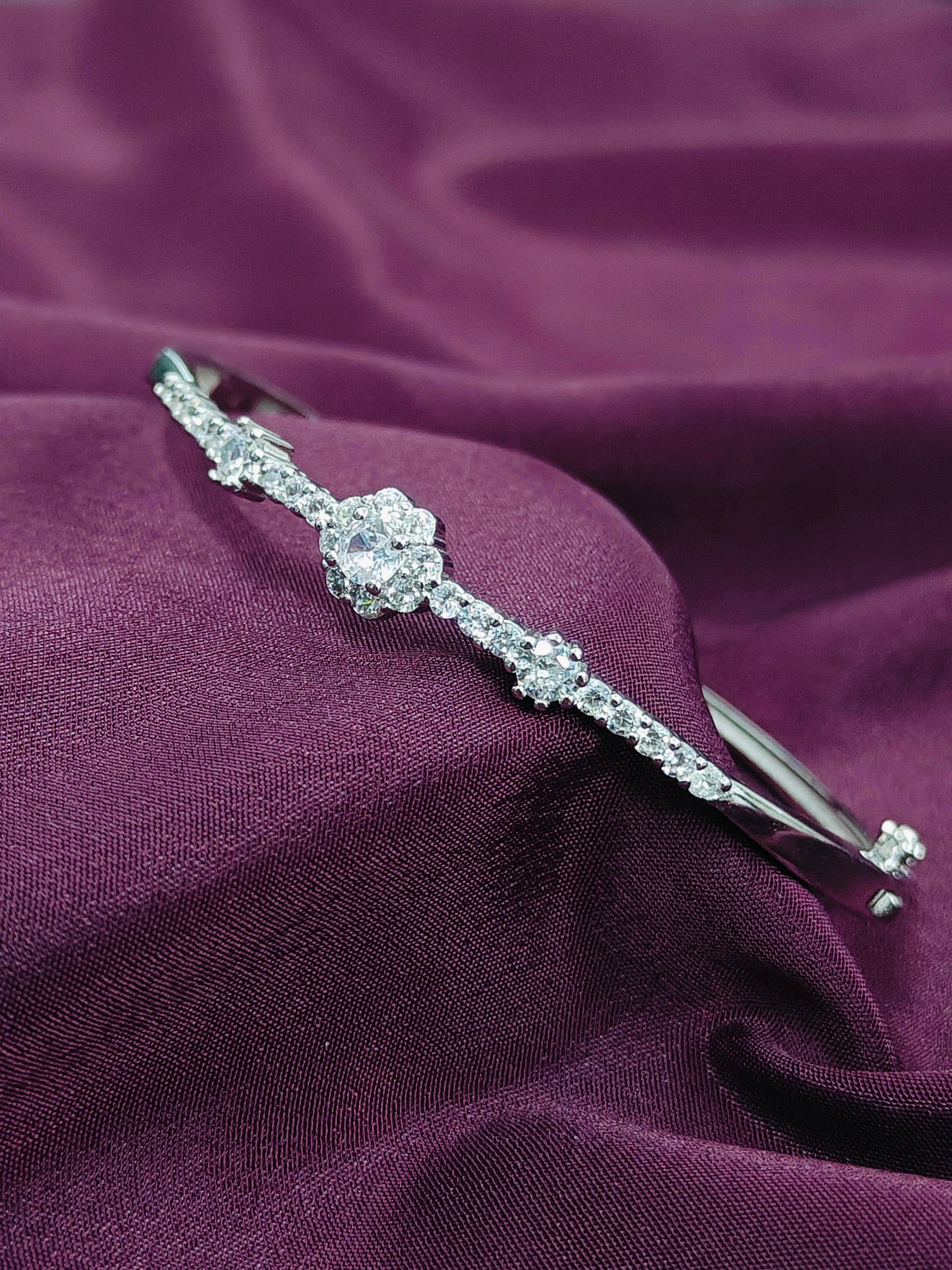 Silver headband with crystals on a purple fabric background